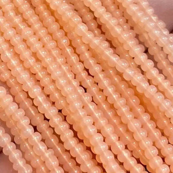 1 Hank Peach Apricot Opal Czech Glass Seed Beads, Size 11/0, close-up view.