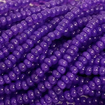 Size 11/0 purple cardinal opal Czech glass seed beads in a hank.