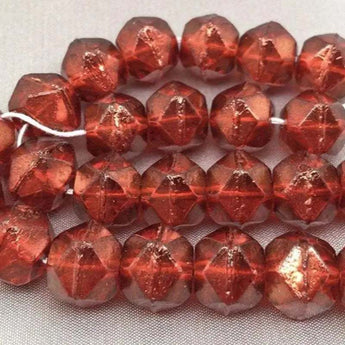 10mm orange persimmon Czech English cut glass beads with rough, non-uniform texture.