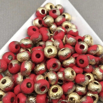 10g etched red gold Czech 2/0 glass seed beads on display.