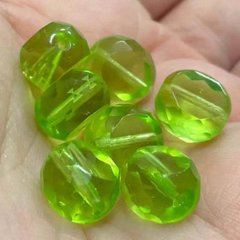 25 translucent green apple Czech coin glass beads, 10mm, with faceted edging and fire polished shine.