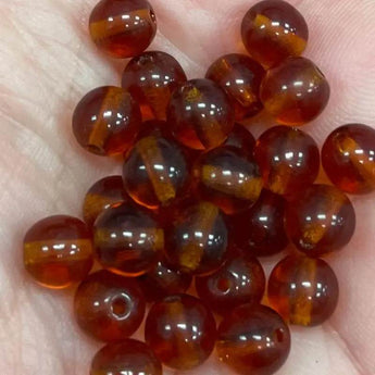 50 amber Czech round glass beads measuring 6mm.